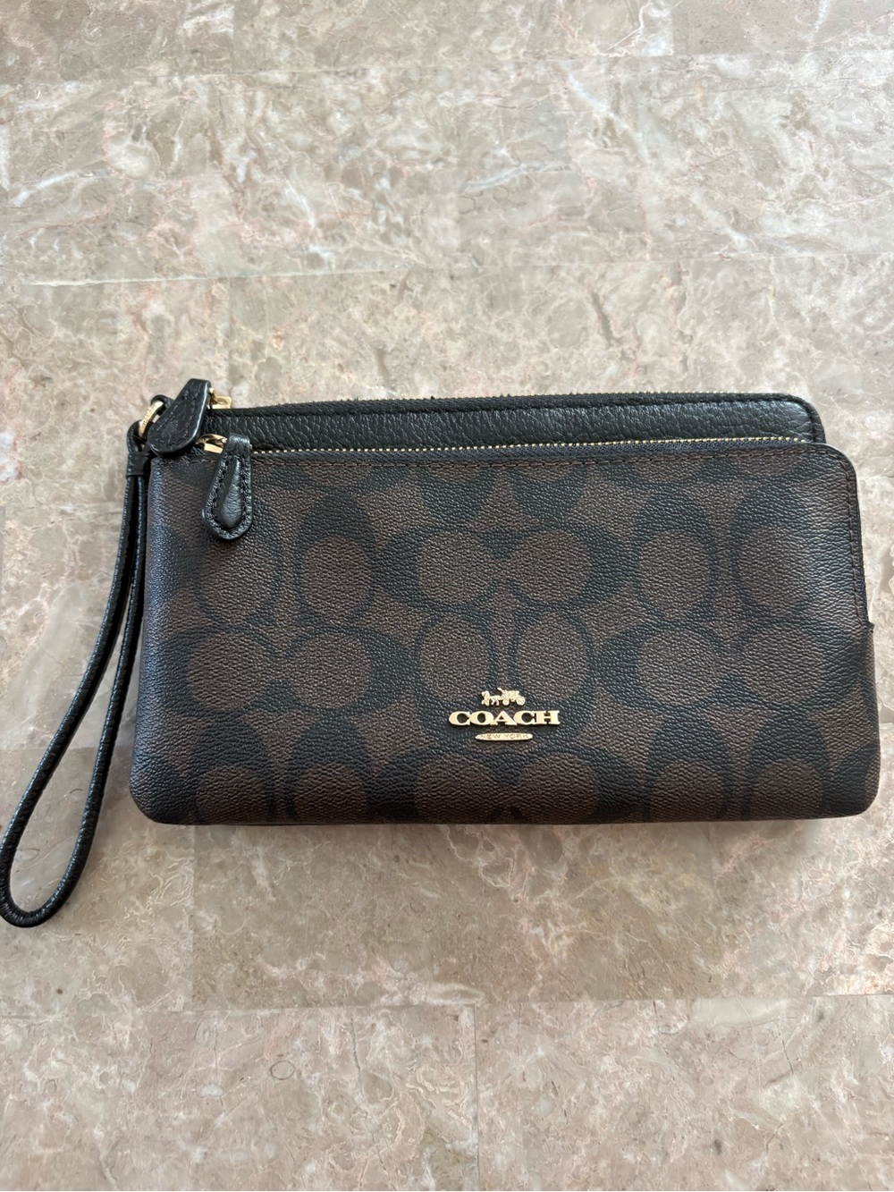 brown and black coach wristlet